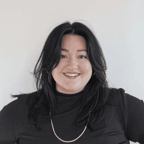 Portrait of Caili M., a professional stylist at Mouton's Salon, showcasing their expertise and style.