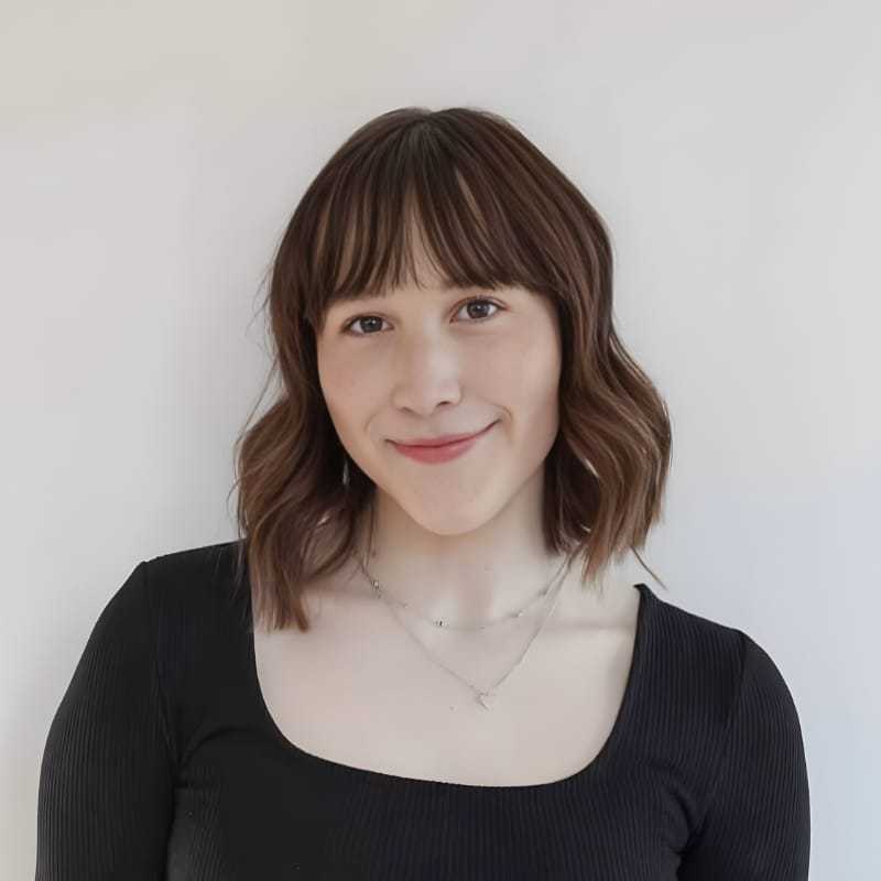 Portrait of Leslie P., a professional stylist at Mouton's Salon, showcasing their expertise and style.
