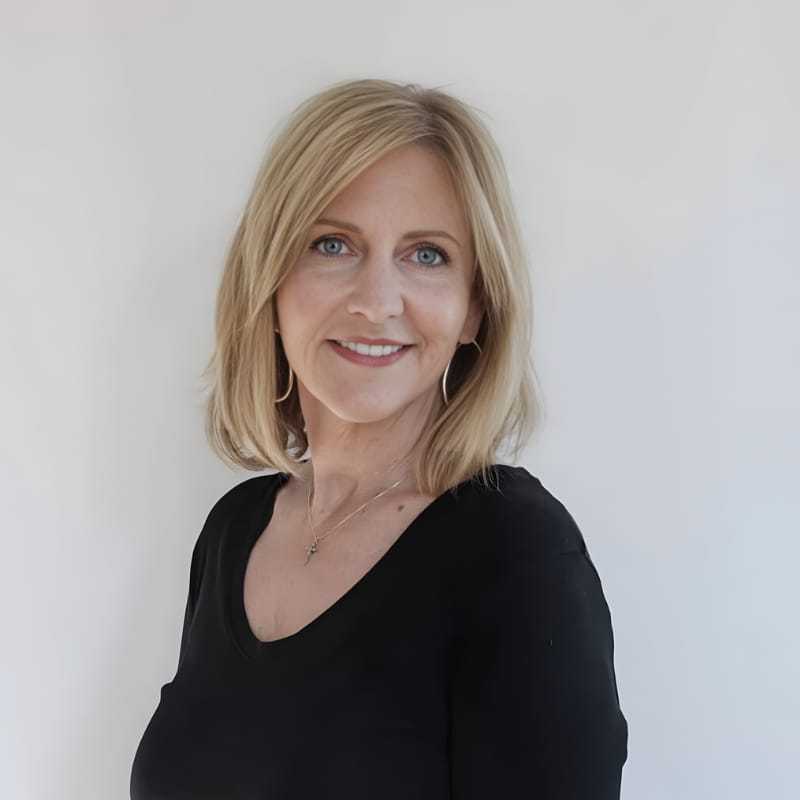 Portrait of Tracy T., a professional stylist at Mouton's Salon, showcasing their expertise and style.