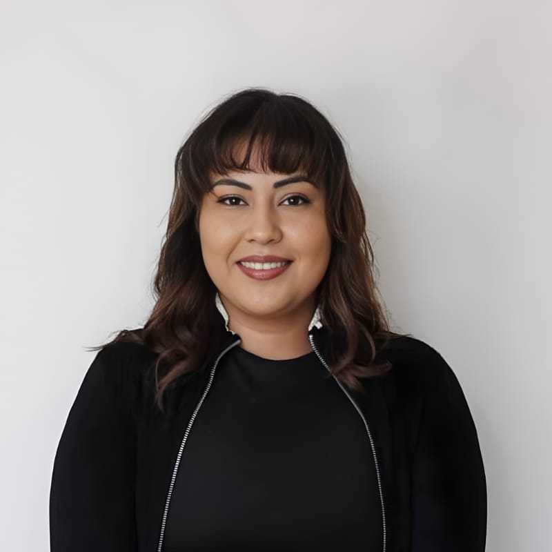 Portrait of Alexandra C., a professional stylist at Mouton's Salon, showcasing their expertise and style.