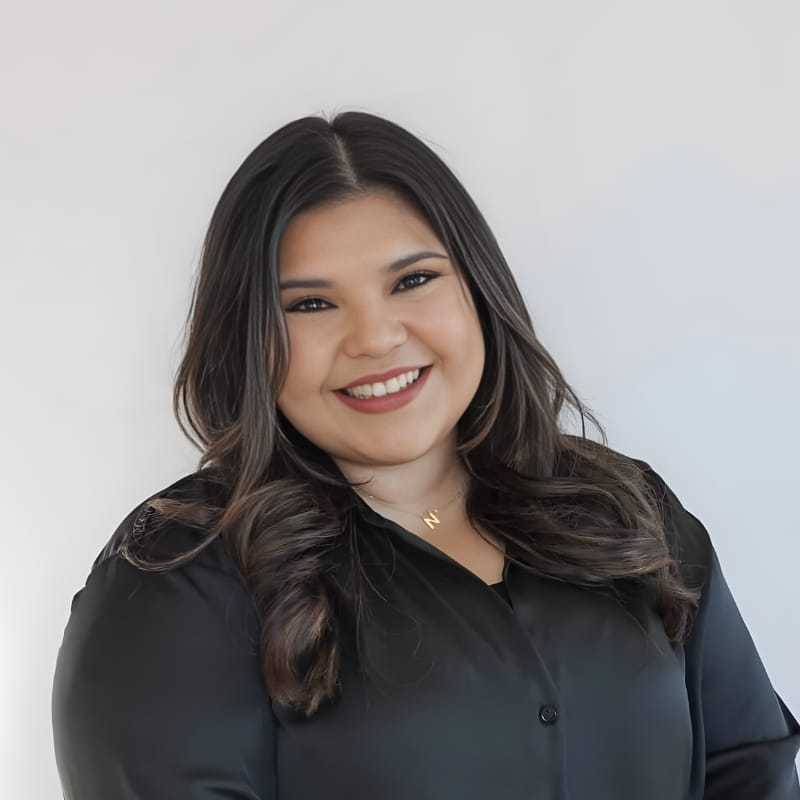 Portrait of Naomi M., a professional stylist at Mouton's Salon, showcasing their expertise and style.