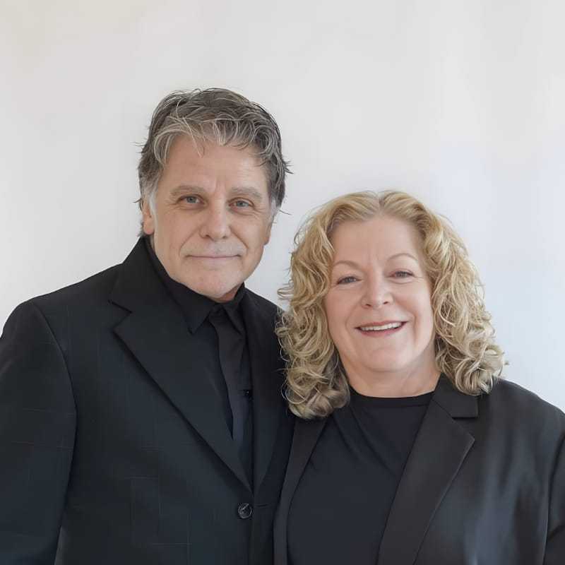 Portrait of Bruce & Teresea, a professional stylist at Mouton's Salon, showcasing their expertise and style.