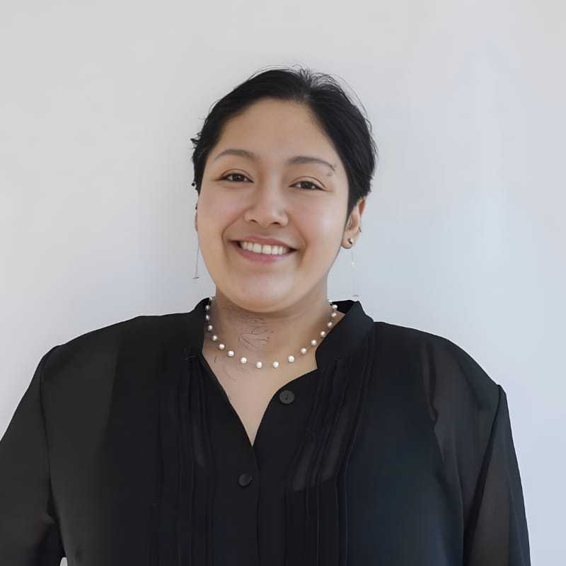Portrait of Ruthy S., a professional stylist at Mouton's Salon, showcasing their expertise and style.