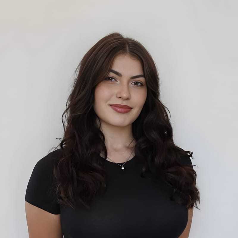 Portrait of Kaitlin P., a professional stylist at Mouton's Salon, showcasing their expertise and style.