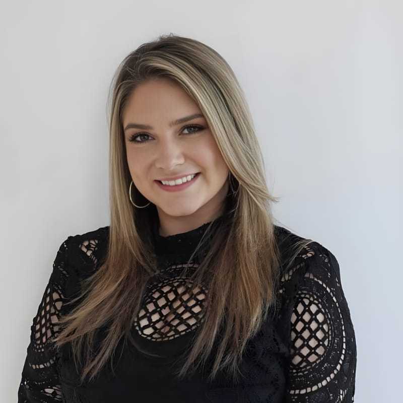 Portrait of Shae B., a professional stylist at Mouton's Salon, showcasing their expertise and style.