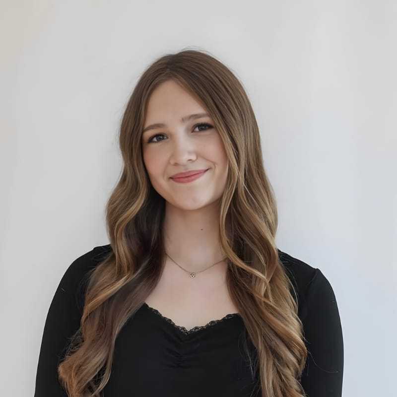 Portrait of Cece D., a professional stylist at Mouton's Salon, showcasing their expertise and style.
