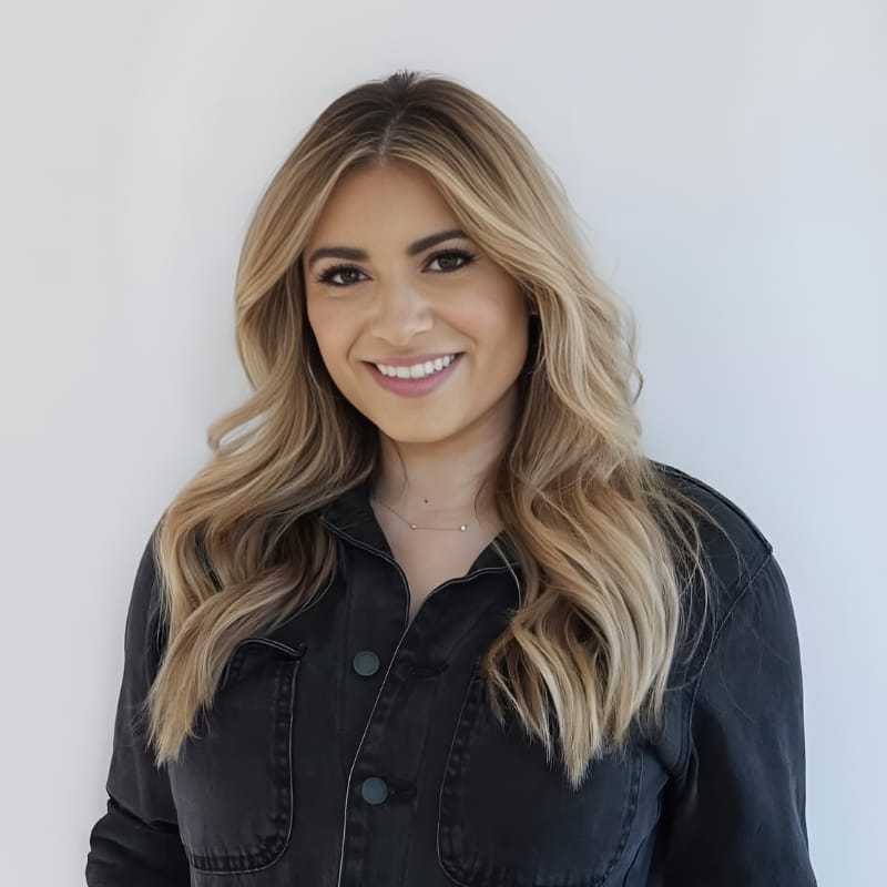 Portrait of Helena M., a professional stylist at Mouton's Salon, showcasing their expertise and style.