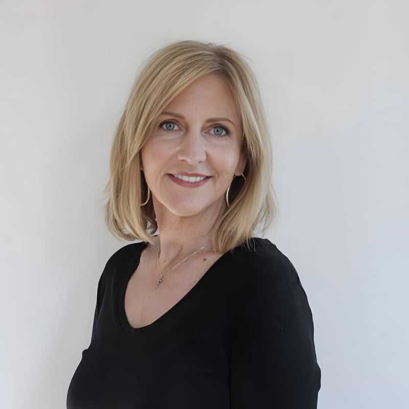Portrait of Tracy Tarbet, a professional stylist at Mouton's Salon, showcasing their expertise and style.