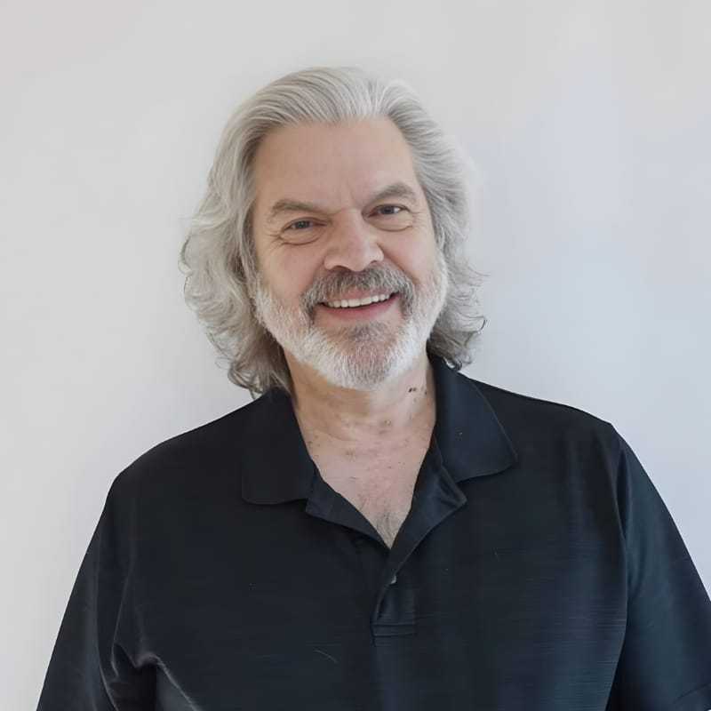 Portrait of Jack F., a professional stylist at Mouton's Salon, showcasing their expertise and style.