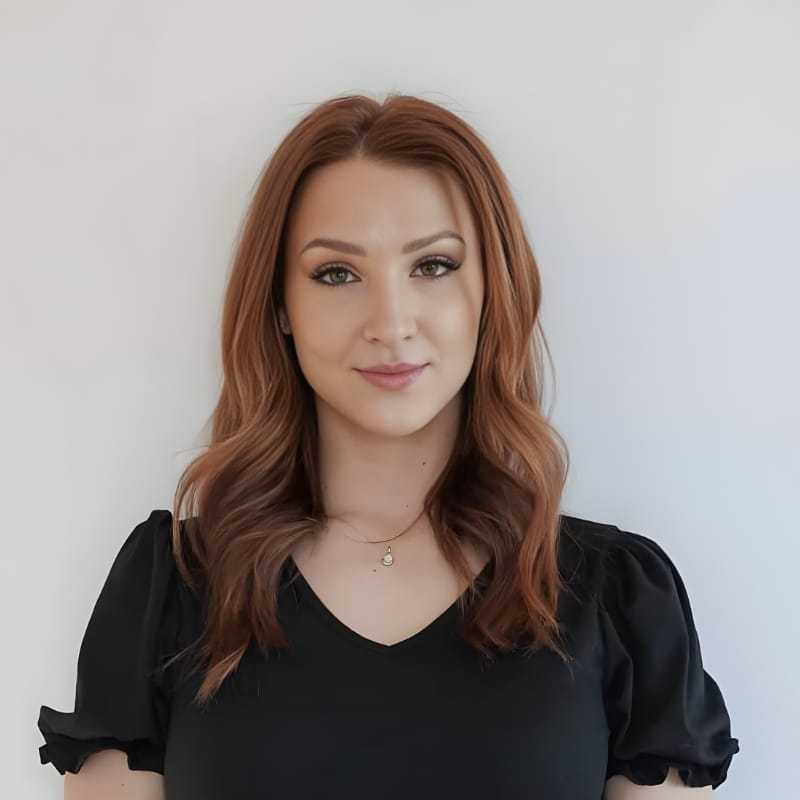 Portrait of Katie M., a professional stylist at Mouton's Salon, showcasing their expertise and style.
